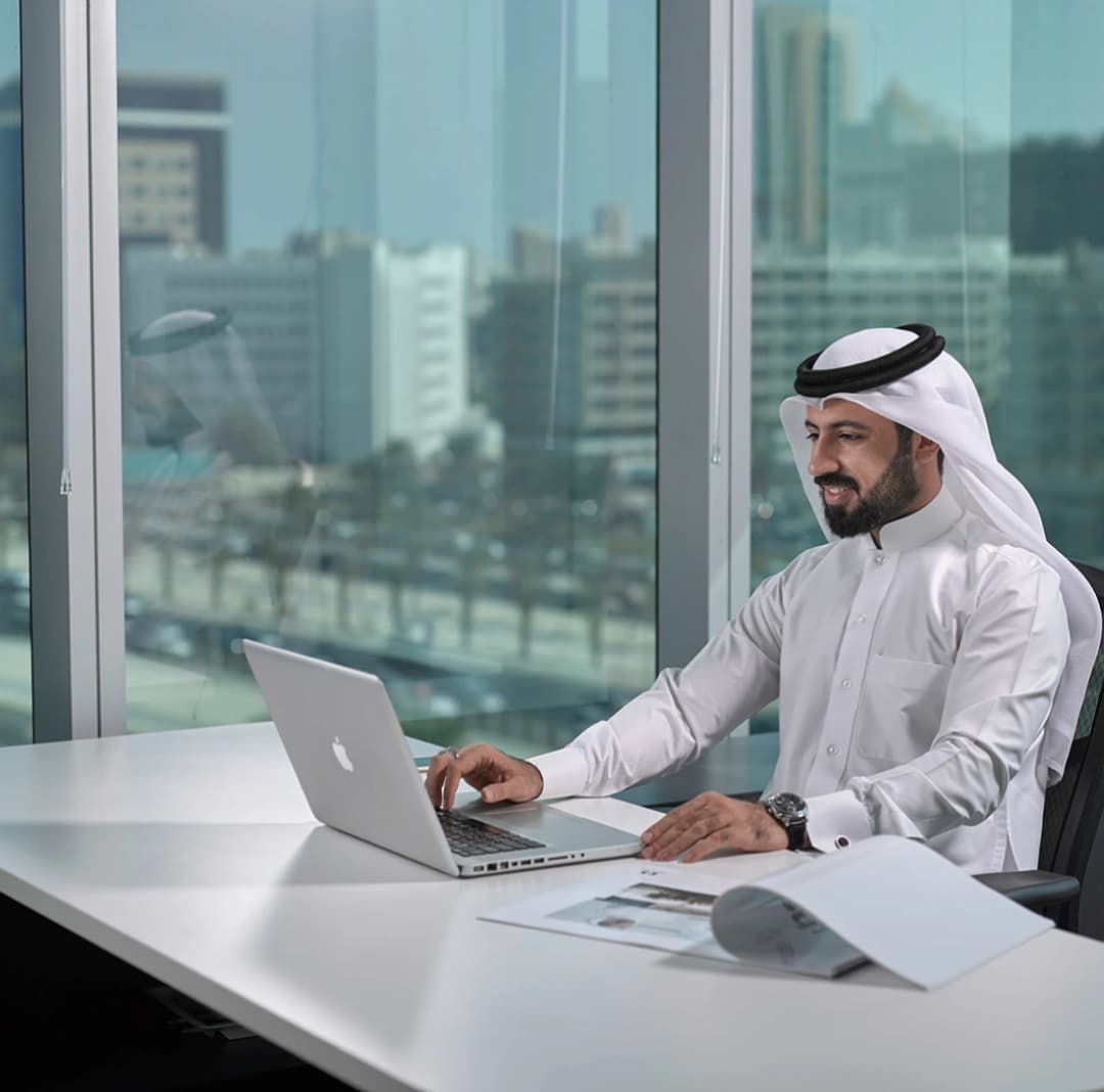 Professional working on laptop in modern office